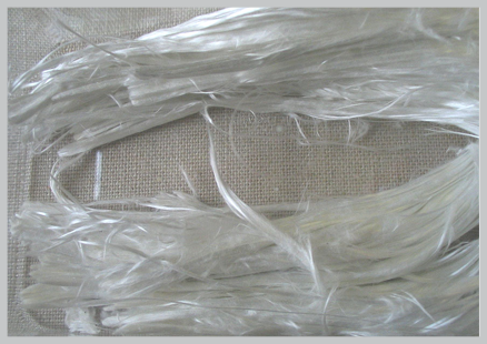 white asbestos fibers on a taupe piece of cloth